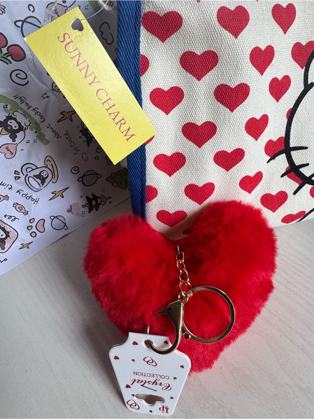 Hello Kitty Canvas Crossbody Bag in Red, Blue, Cream with Plush Red Heart Charm - Picture 6 of 8